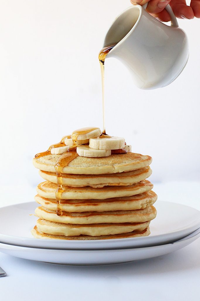 Finished recipe stacked on a white plate with maple syrup