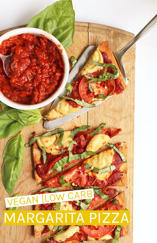 This Vegan Pizza Margherita is made with a thin crust, homemade tomato sauce, and vegan mozzarella for a delicious plant-based classic pizza. #vegan #veganpizza #pizza #vegancheese #vegetarianpizza #veganrecipes