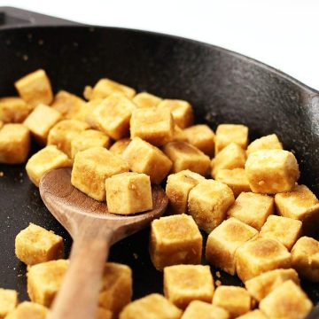Cubed and sautéd tofu in a skillet