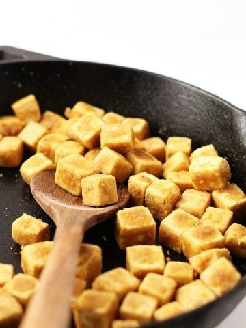 Cubed and sautéd tofu in a skillet