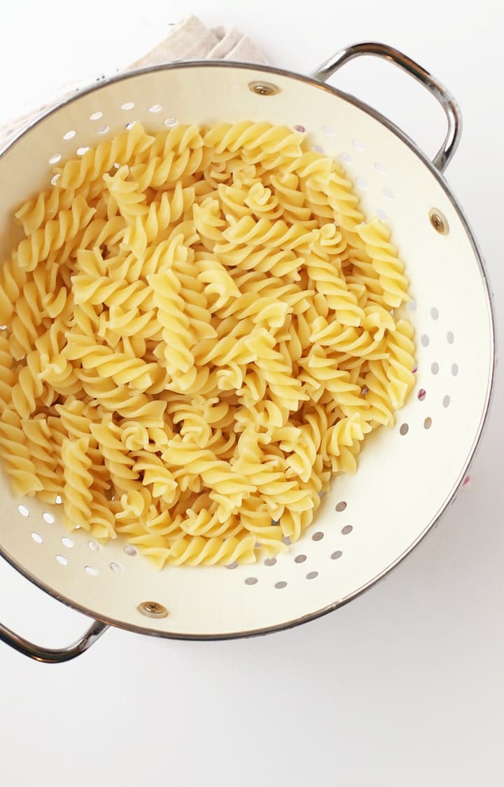 Fusilli pasta in a white colander 
