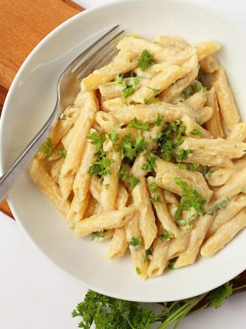 Finished dish in a white bowl with a fork