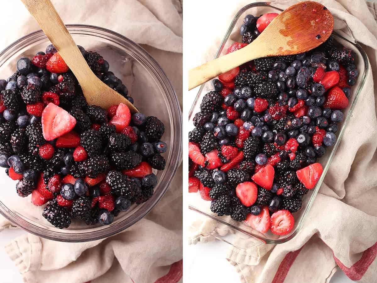 Mixed berries in a glass bowl with a wooden spoon