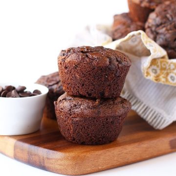 Two chocolate muffins on a wooden board