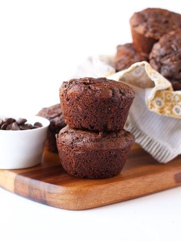 Two chocolate muffins on a wooden board