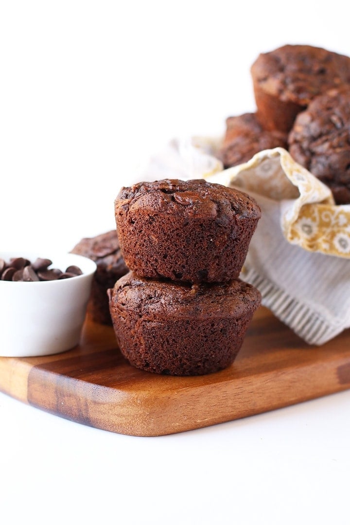 Two chocolate muffins on a wooden board