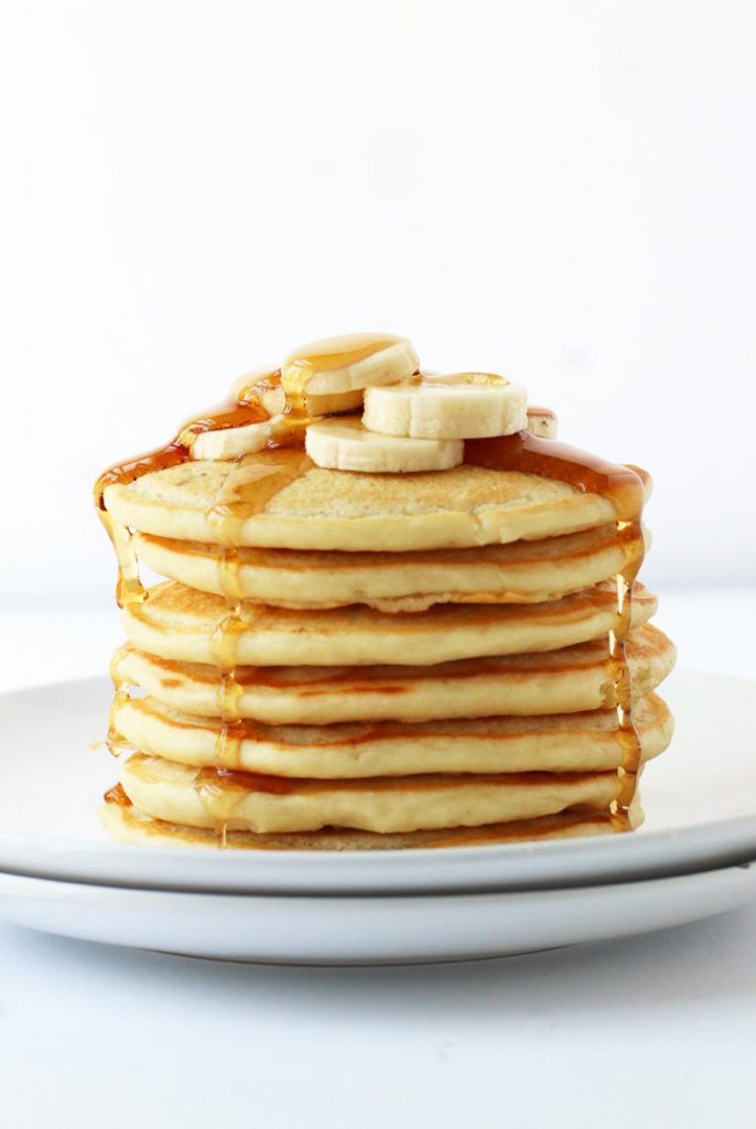 Finished recipe stacked on a white plate with maple syrup