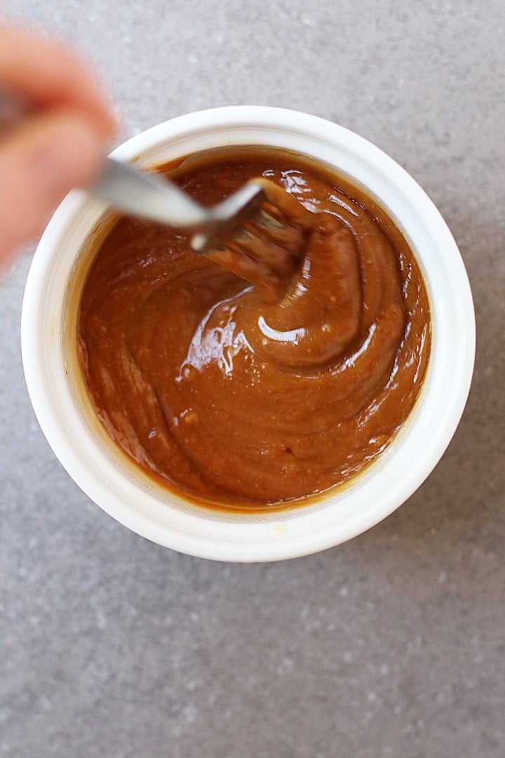 Peanut sauce in a small white bowl whisked together