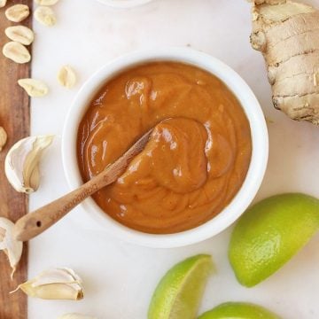 Finished sauce on a marble platter with limes and peanuts