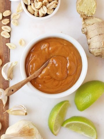 Finished sauce on a marble platter with limes and peanuts