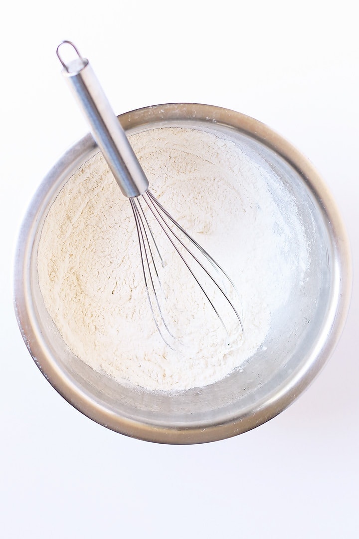 Flour in a bowl with a whisk