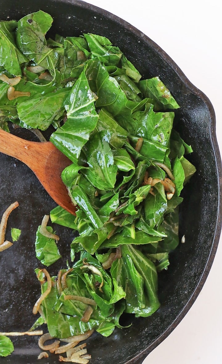 Sautéed Collard Greens in a cast iron skillet. 