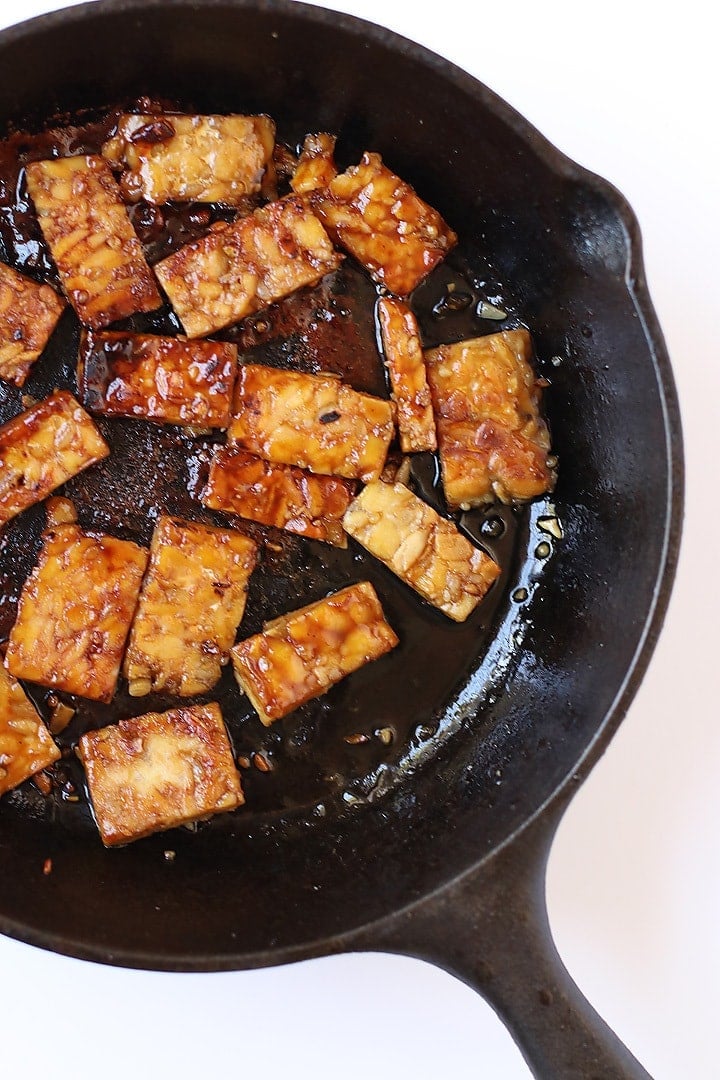 Sautéed tempeh in a cast iron skillet.