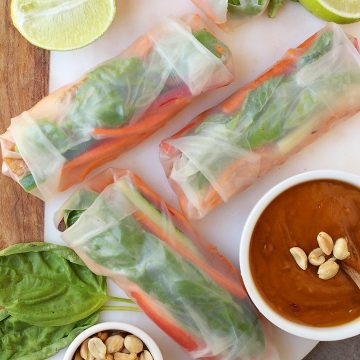 Finished spring rolls on a platter with peanut sauce