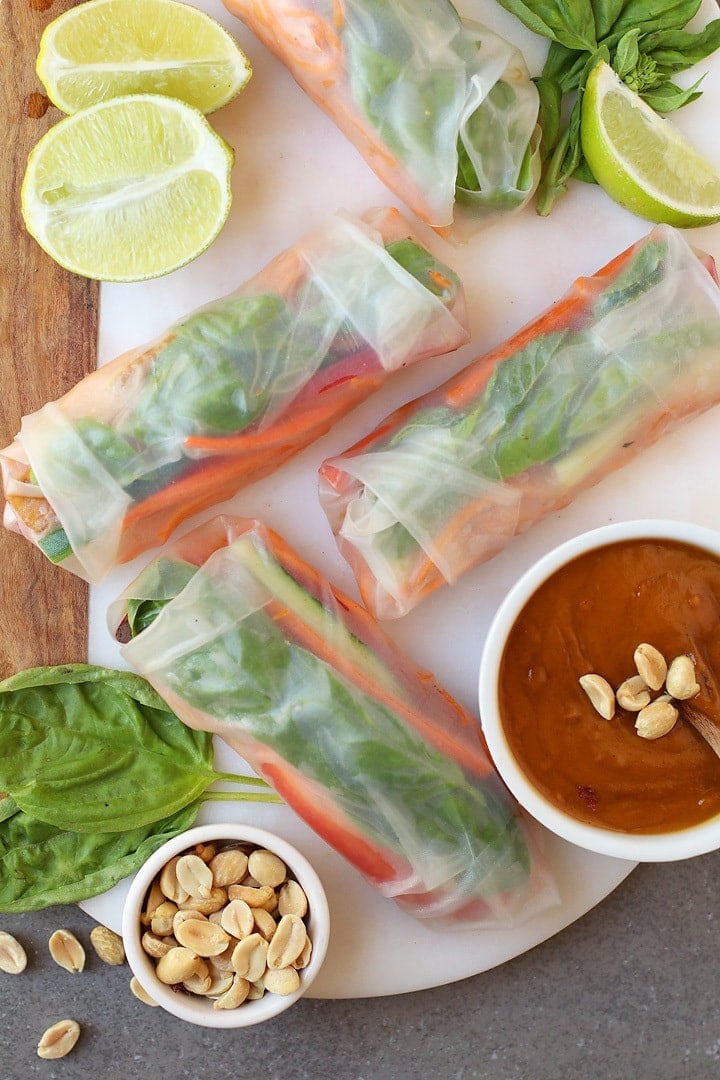 Finished spring rolls on a platter with peanut sauce