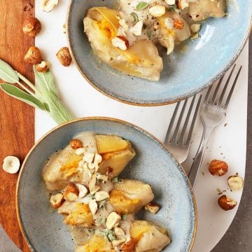 Finished dish in two white bowls on a marble platter