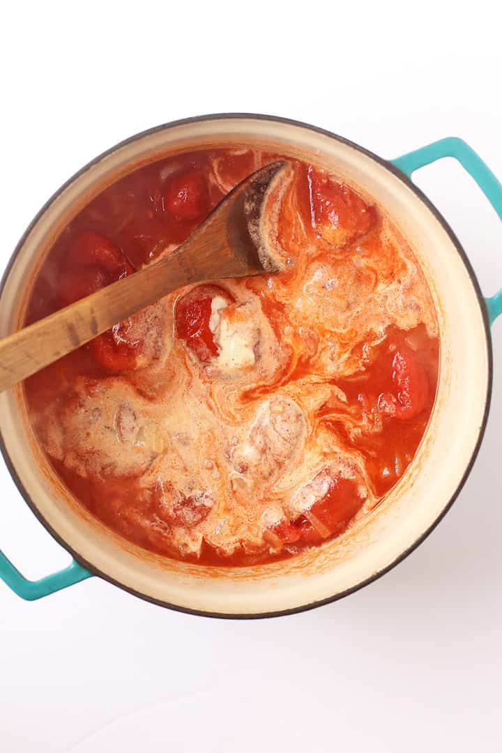 Tomatoes and cashew cream in a soup pot