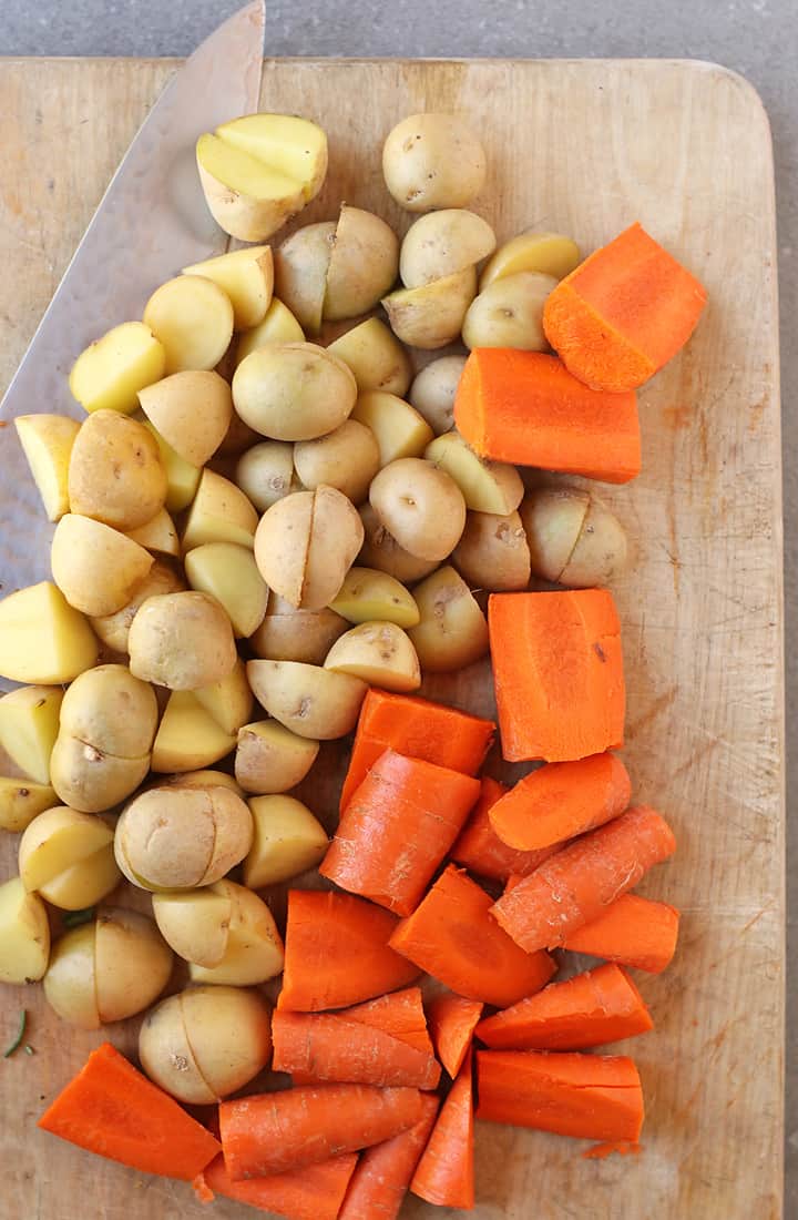Chopped potatoes and carrots on a cutting board