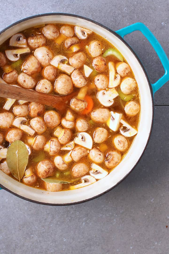 Sautéed vegetables in a large soup pot