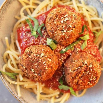 Vegan Meatballs with Tempeh Served over spaghetti and pasta sauce.