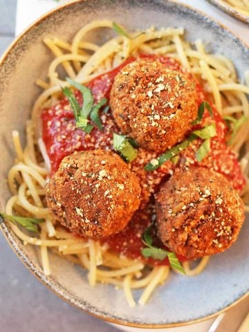 Vegan Meatballs with Tempeh Served over spaghetti and pasta sauce.
