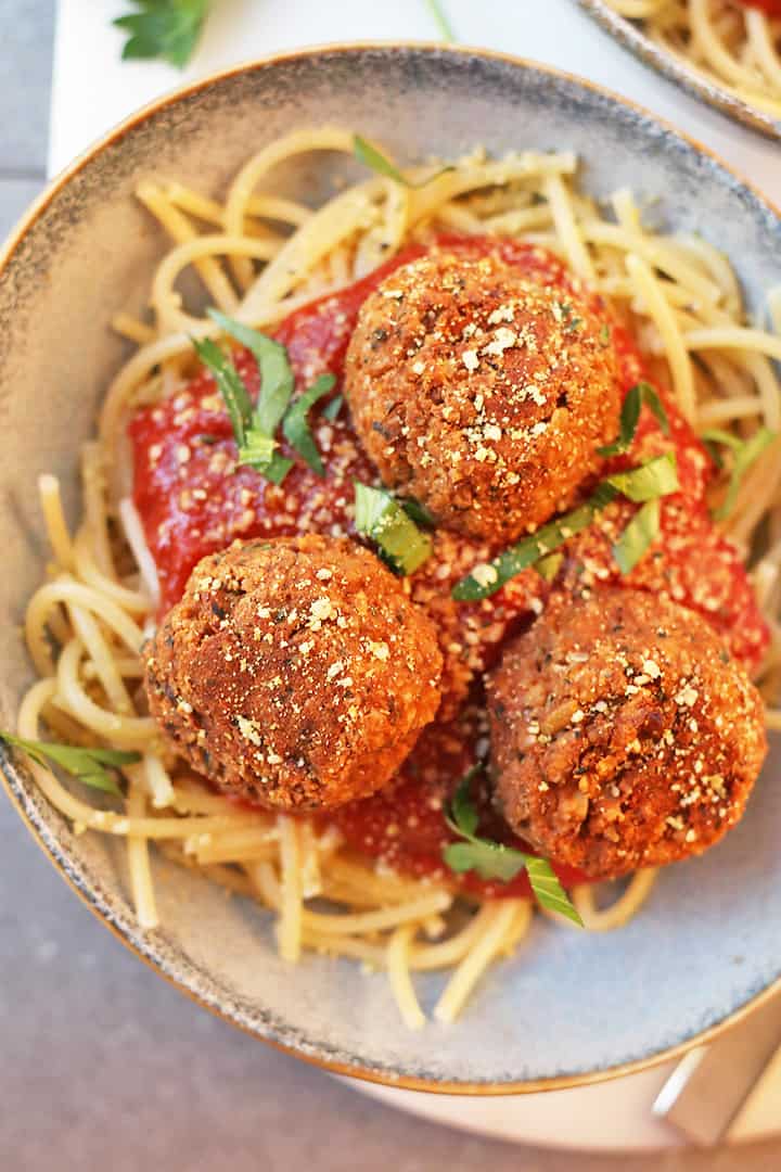 Vegan Meatballs with Tempeh Served over spaghetti and pasta sauce.