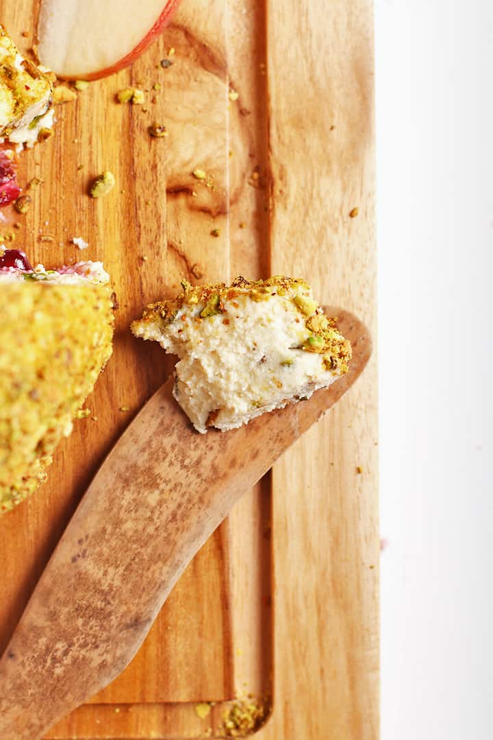 Slice of vegan cheese on a wooden knife