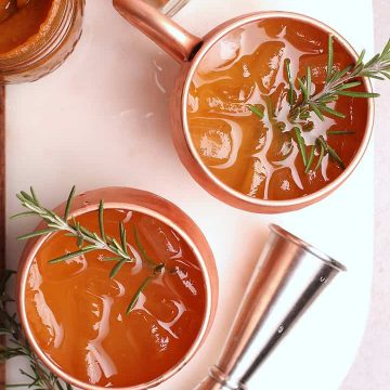 Moscow Mule recipe in a copper mug with rosemary.