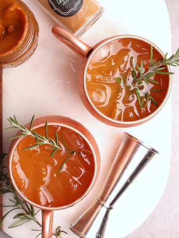 Moscow Mule recipe in a copper mug with rosemary.