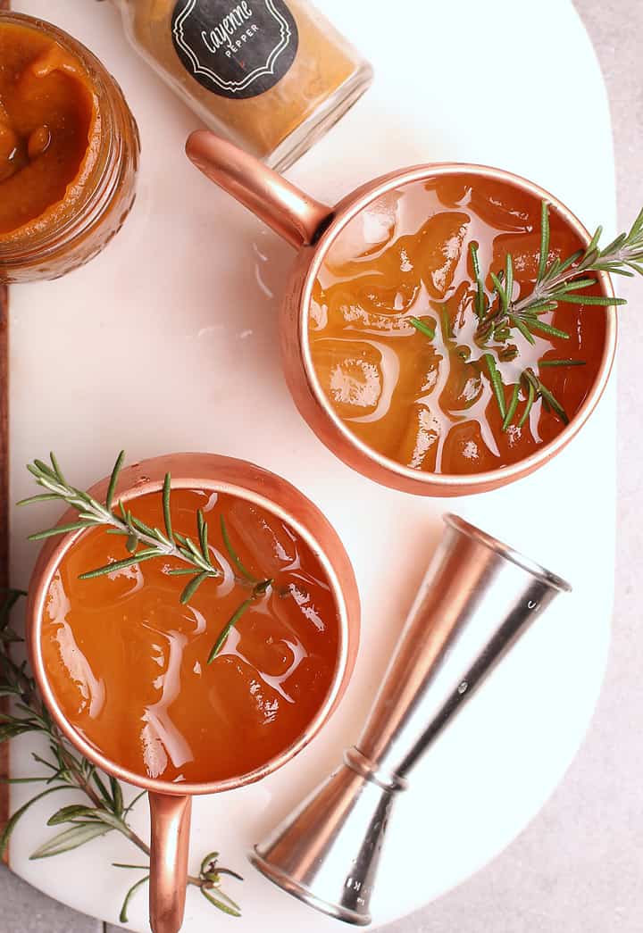 Moscow Mule recipe in a copper mug with rosemary.