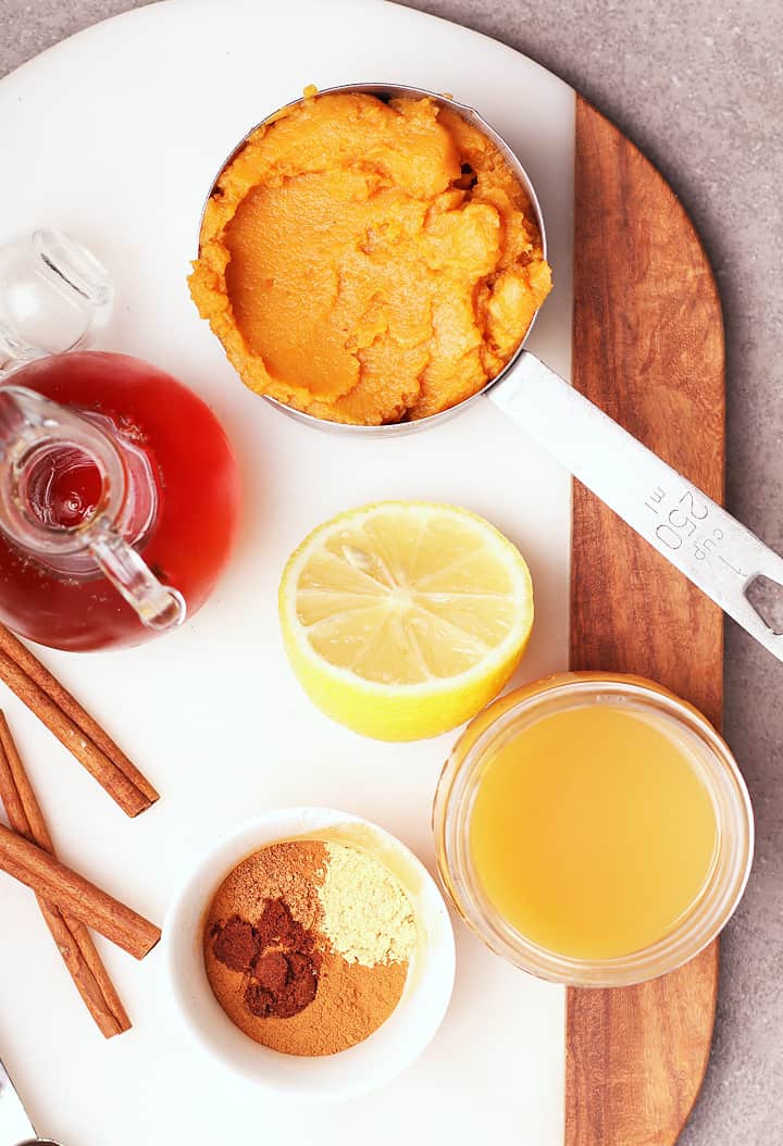 Pumpkin puree, lemon juice, maple syrup, and spices on a marble board