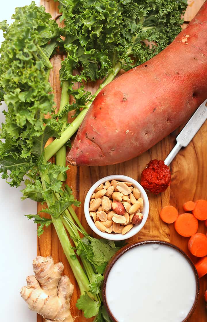 Sweet potatoes, kale, and peanuts on cutting board