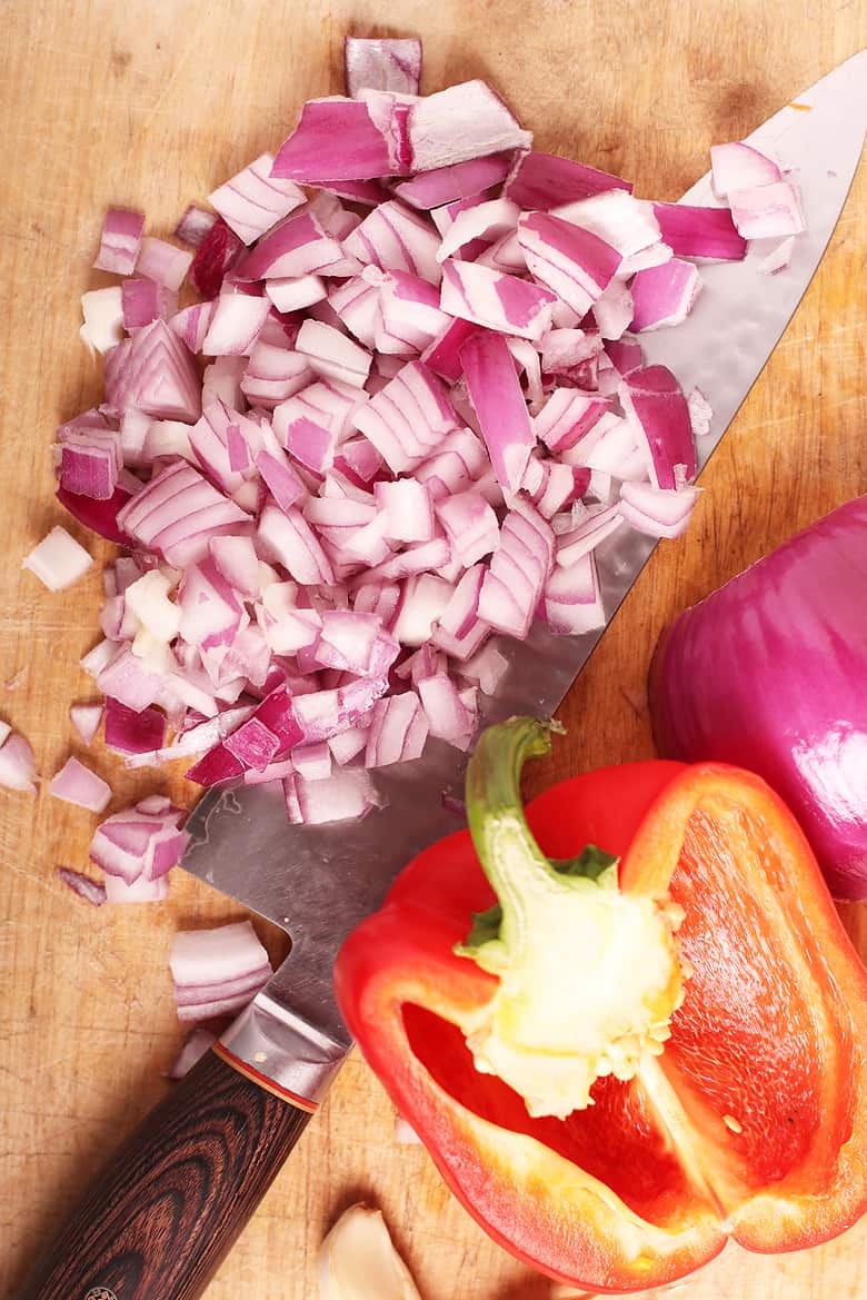 diced red onion and pepper on a cutting board