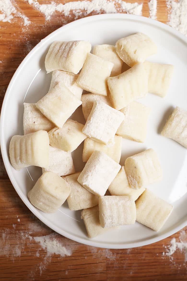 Raw gnocchi on white plate