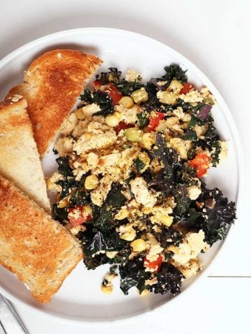 Finished dish on a white plate with toast