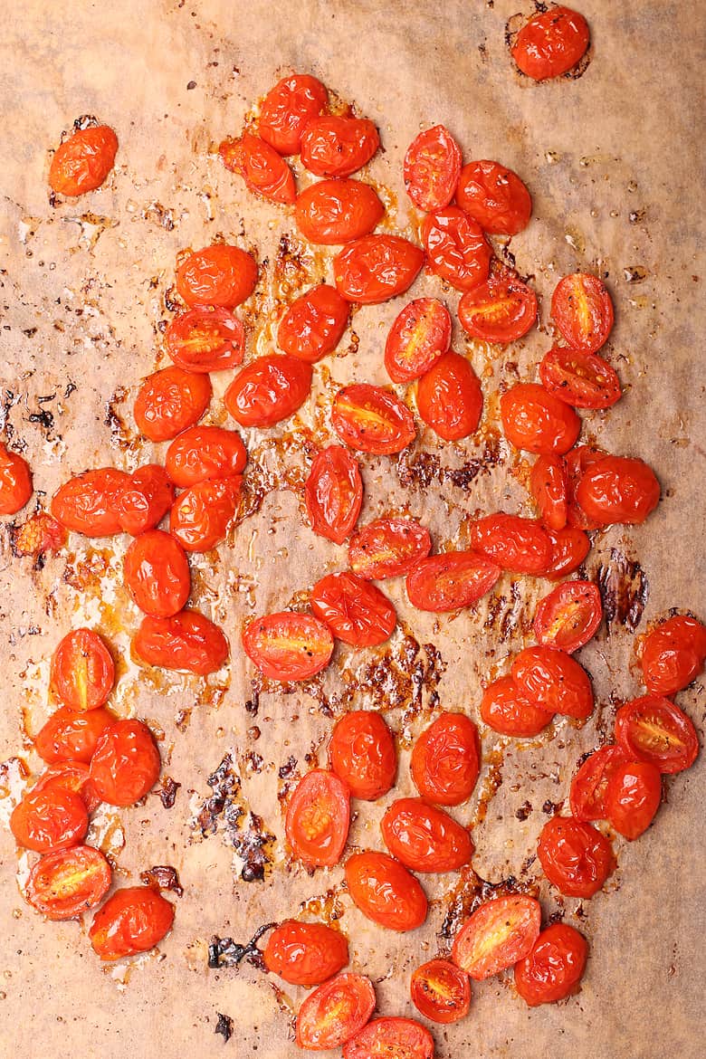 Roasted cherry tomatoes on a baking sheet