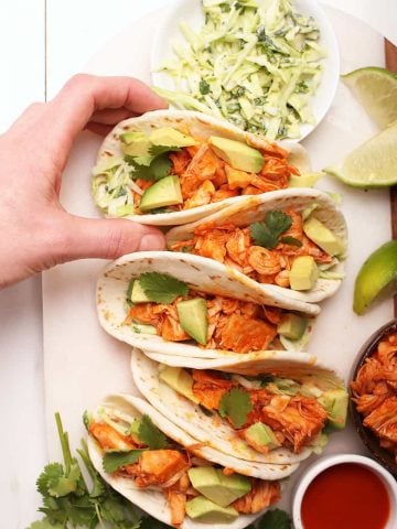 Buffalo Jackfruit tacos on a white board