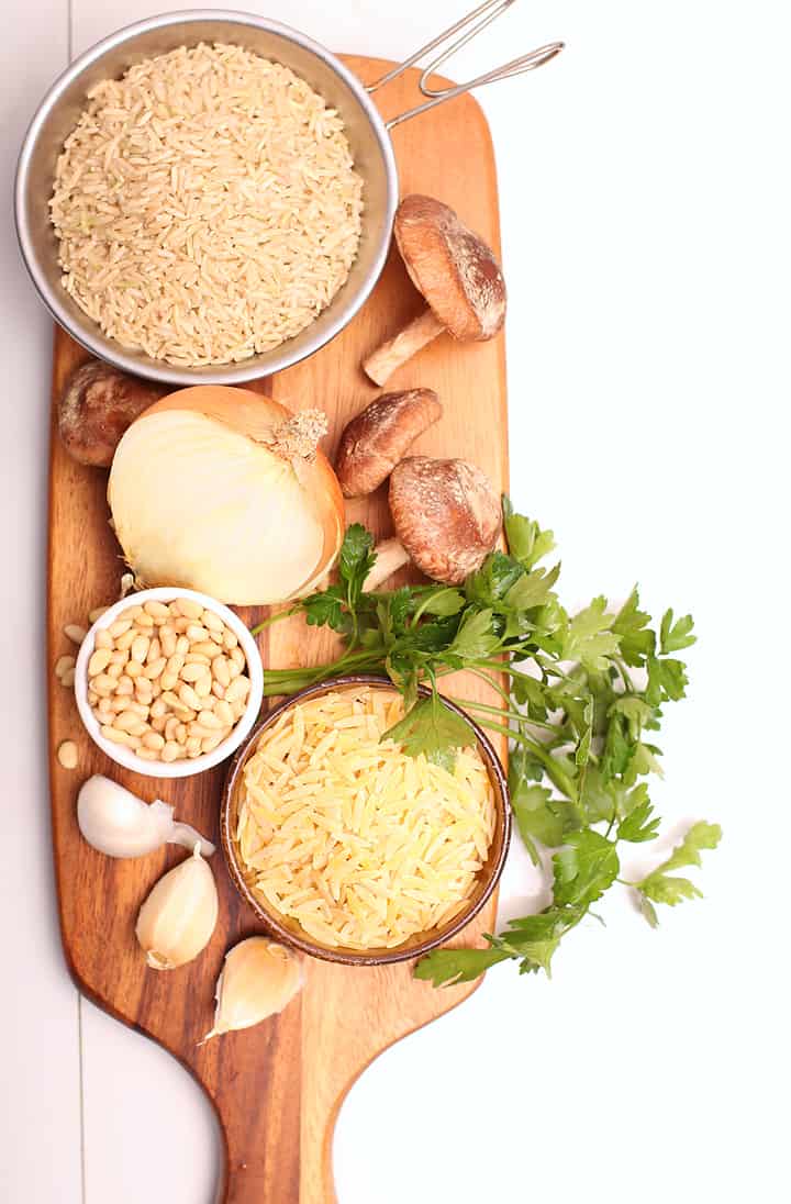 Orzo, brown rice, and mushrooms on a cutting board