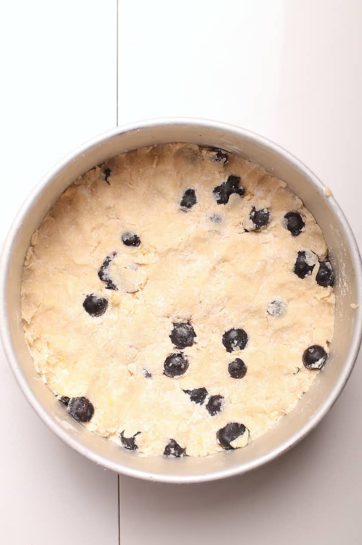 Unbaked vegan scones pressed into a cake pan