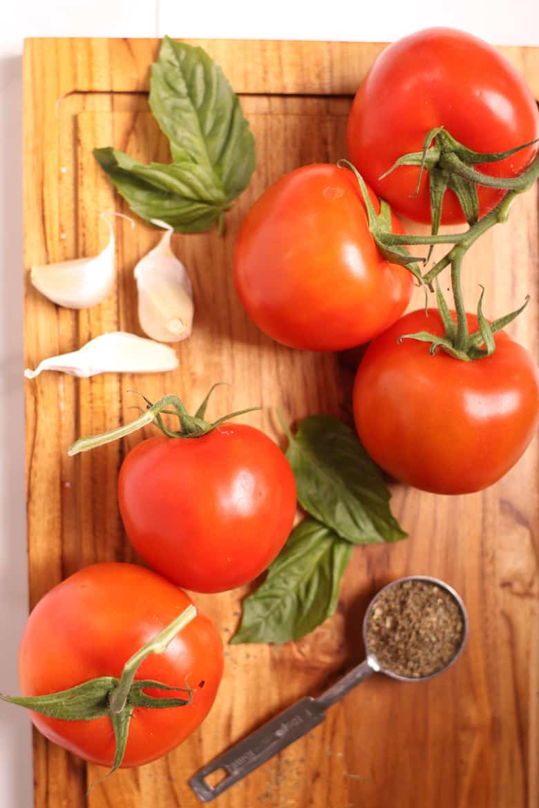 Tomatoes and basil on a cutting board