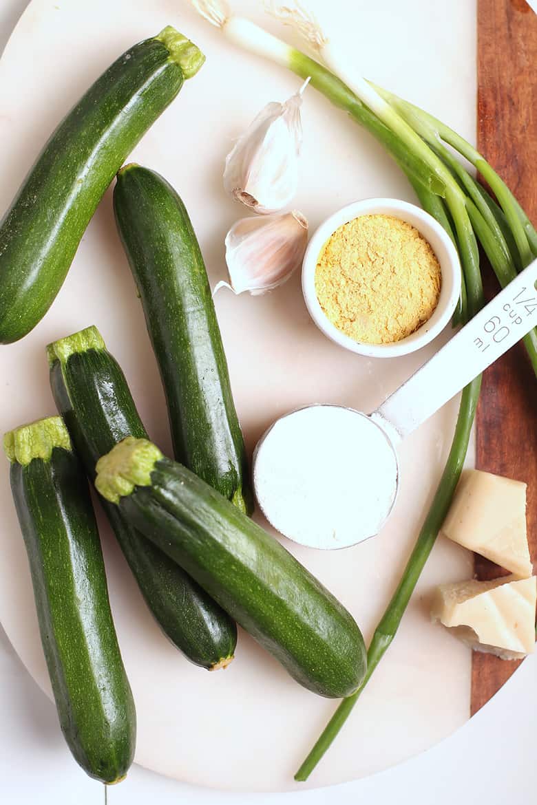 Zucchinis and garlic on white marble board