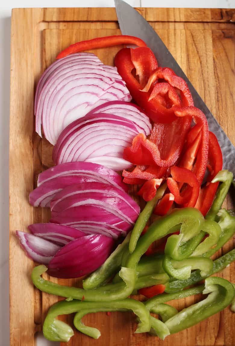 Chopped onions and peppers on cutting board