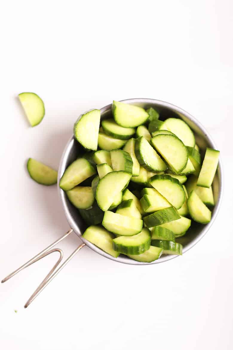 Chopped cucumbers in a metal bowl