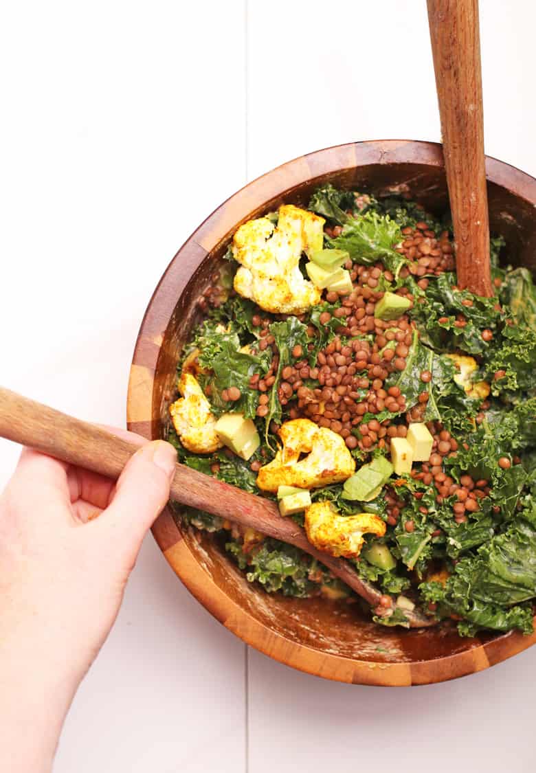 Finished salad in a wooden mixing bowl