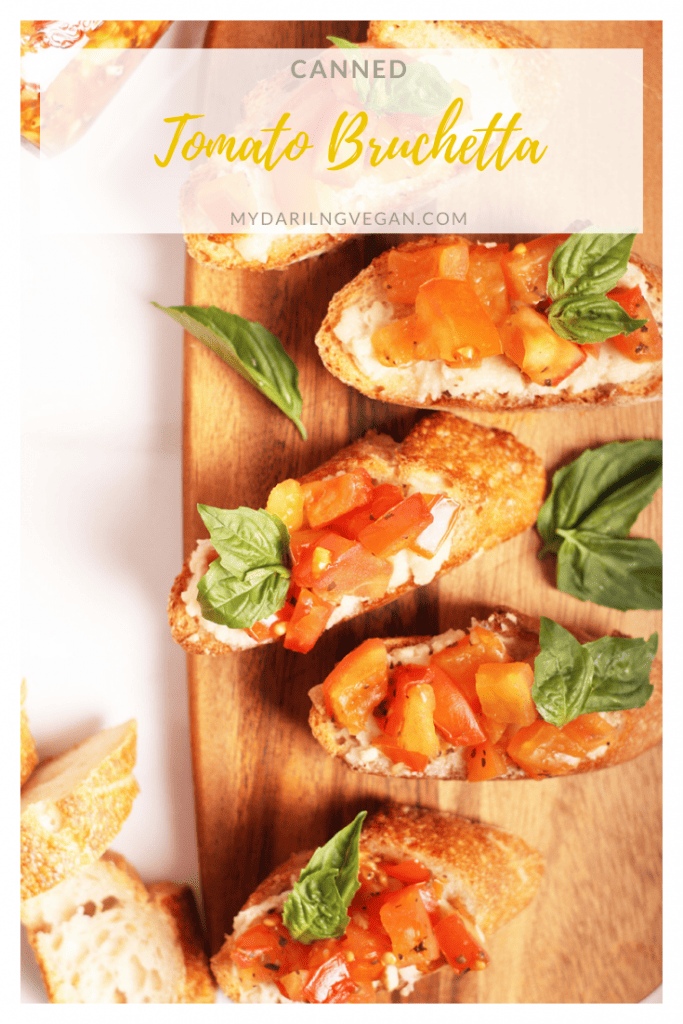 Tomato bruschetta in a jar! Served over soft vegan mozzarella cheese and a toasted baguette for a sweet and tangy baked appetizer. Make it in a jar for the perfect spread, filling, or homemade gift. 