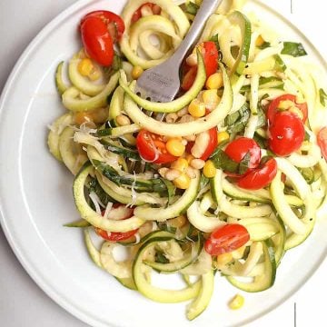 Zucchini noodle salad on white plate