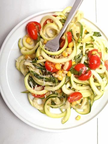 Zucchini noodle salad on white plate