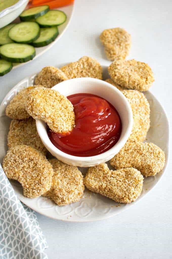 Vegan Chicken Nuggets on a white plate with ketcup