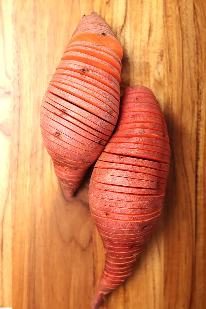 Thinly sliced Sweet Potatoes on cutting board