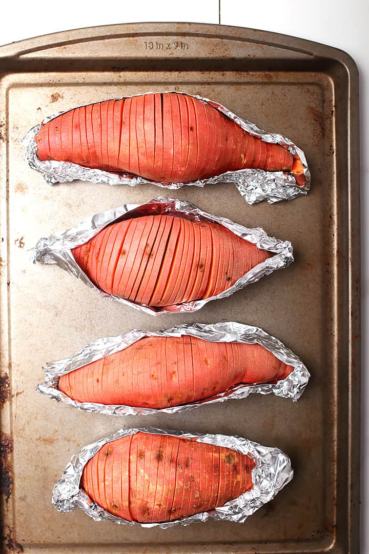 Hasselback sweet potatoes on baking sheet